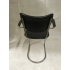 Zwevende vintage design buisframe stoel van De Wit, met zwarte skai bekleding en bakelieten armleggers